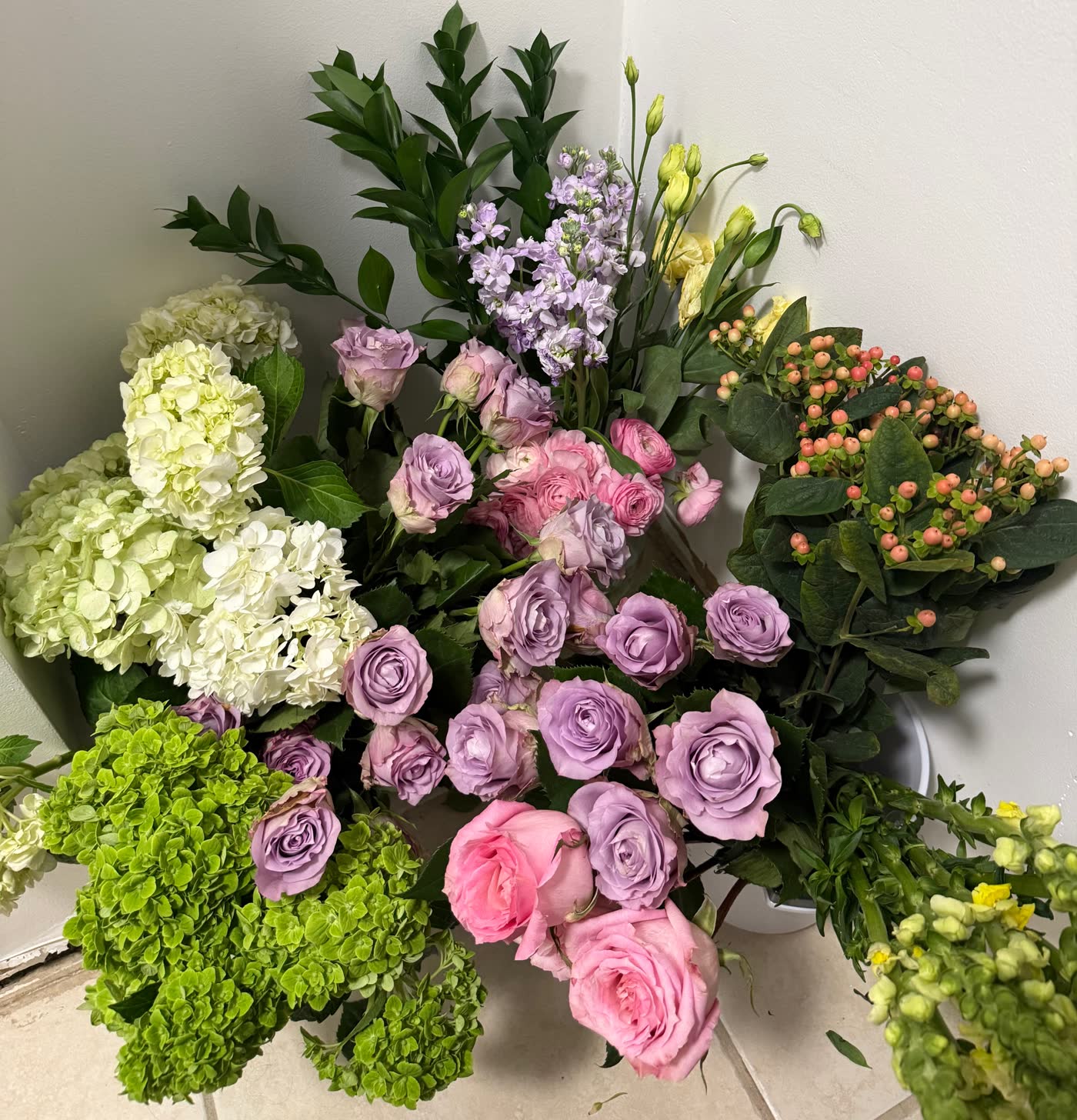 Chloe's bouquet of lilac and pink roses, ranunculus and green hydrangeas