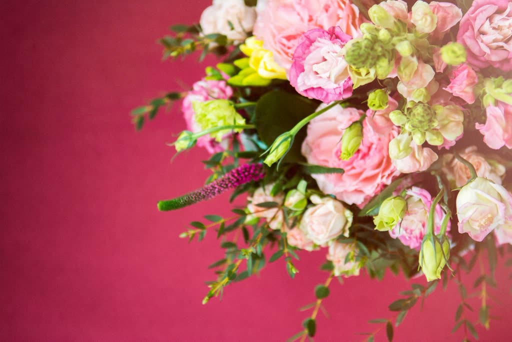 Pink roses, peonies and mixed garden flowers against a rose background